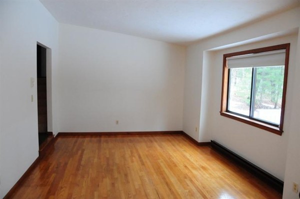 17 Michael Road Bourne, MA 02559 - Photo 6 of 12 a view of an empty room with wooden floor and a window