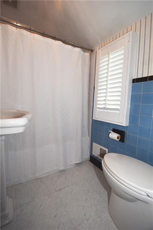 541 Haverhill Road Pittsburgh, PA 15228 - Photo 13 of 28 a white toilet sitting next to a bathroom sink and a shower