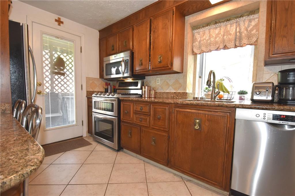 541 Haverhill Road Pittsburgh, PA 15228 - Photo 19 of 28 a kitchen with stainless steel appliances granite countertop a stove sink and cabinets