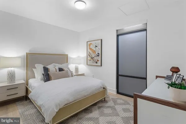 a bedroom with a bed and a large window