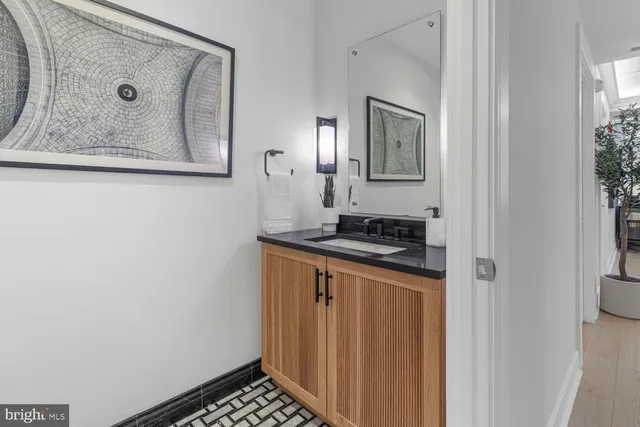 a bathroom with a granite countertop bathtub sink vanity mirror and toilet