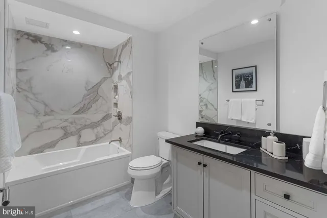 a bathroom with a toilet a sink and bathtub