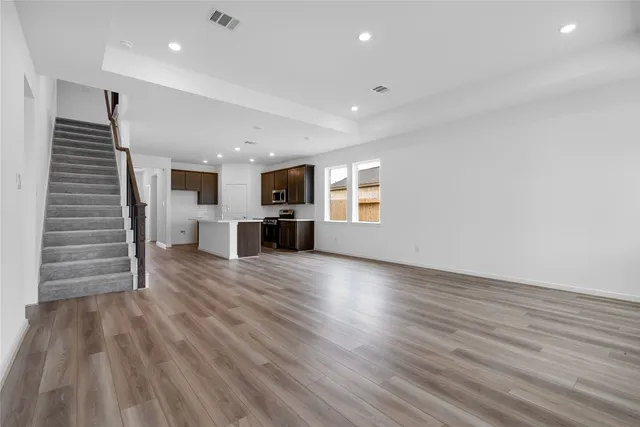 a view of kitchen with furniture and wooden floor