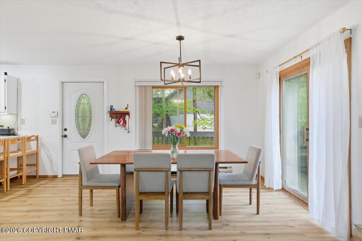 126 Dunchurch Drive Bushkill, PA 18324 - Photo 13 of 34 a dining room with furniture a rug and a chandelier