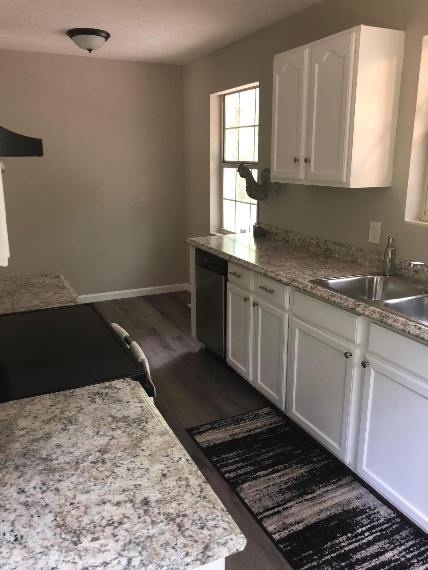 114 Oak Road Powell, TN 37849 - Photo 3 of 12 a kitchen with a sink stove and cabinets