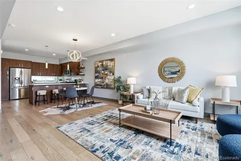 a living room with lots of furniture and paintings on the wall