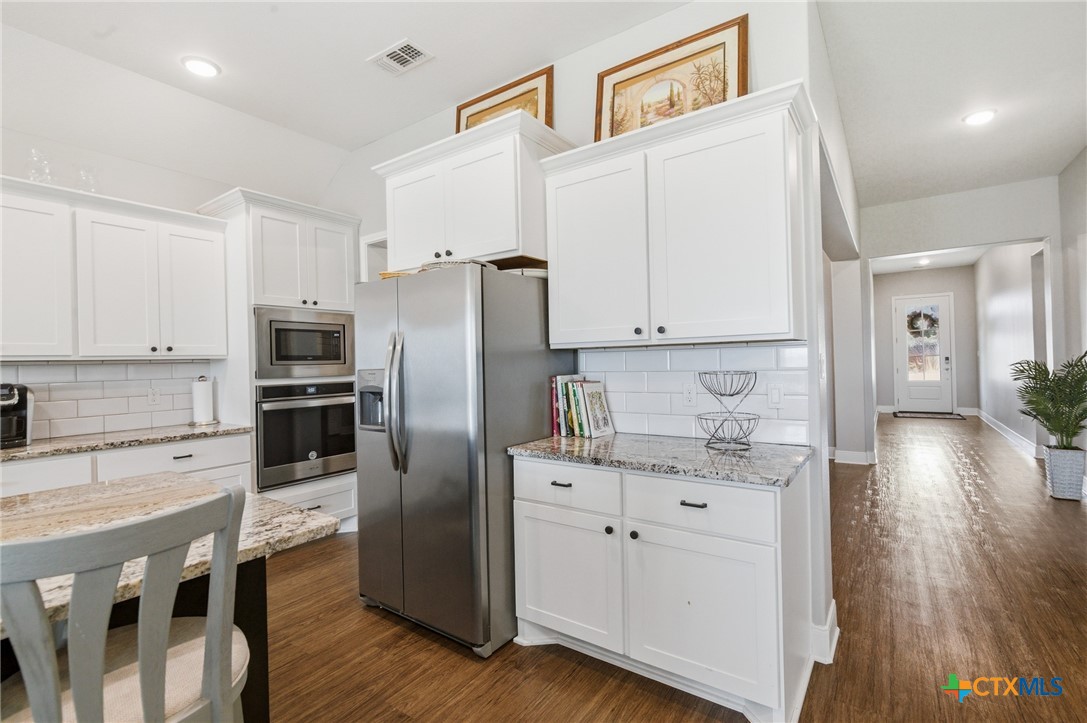 113 Terra Vista Ranch Road Victoria, TX 77904 - Photo 19 of 47 a kitchen with stainless steel appliances a refrigerator sink and cabinets