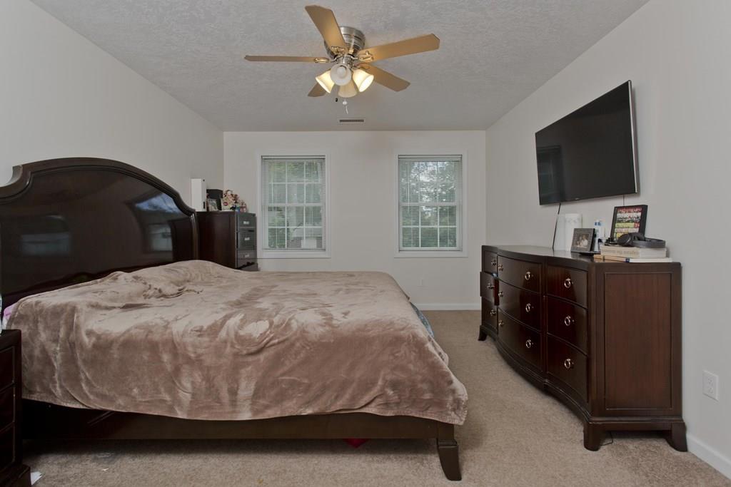 39 Spencer Street Springfield, MA 01118 - Photo 13 of 30 a bedroom with a bed and a flat tv screen on dresser