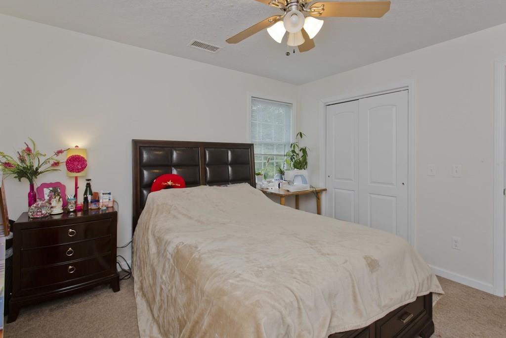 39 Spencer Street Springfield, MA 01118 - Photo 16 of 30 a bed room with a bed and a chandelier