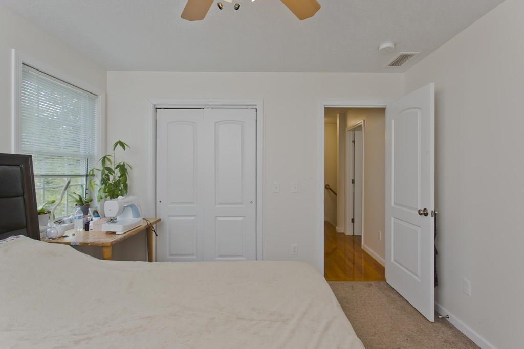39 Spencer Street Springfield, MA 01118 - Photo 17 of 30 a bedroom with a bed and a chandelier