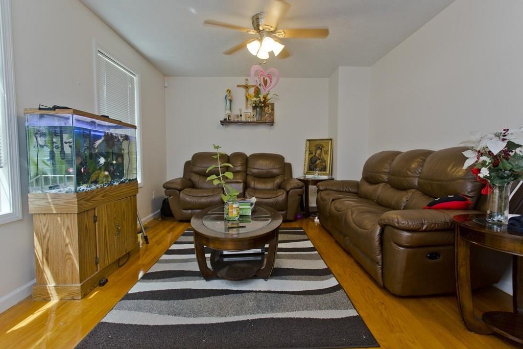 39 Spencer Street Springfield, MA 01118 - Photo 2 of 30 a living room with furniture and a chandelier