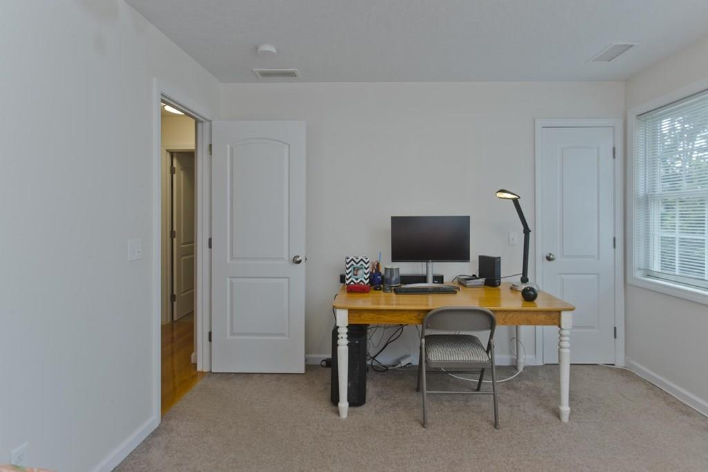 39 Spencer Street Springfield, MA 01118 - Photo 22 of 30 a view of a workspace with furniture and a window