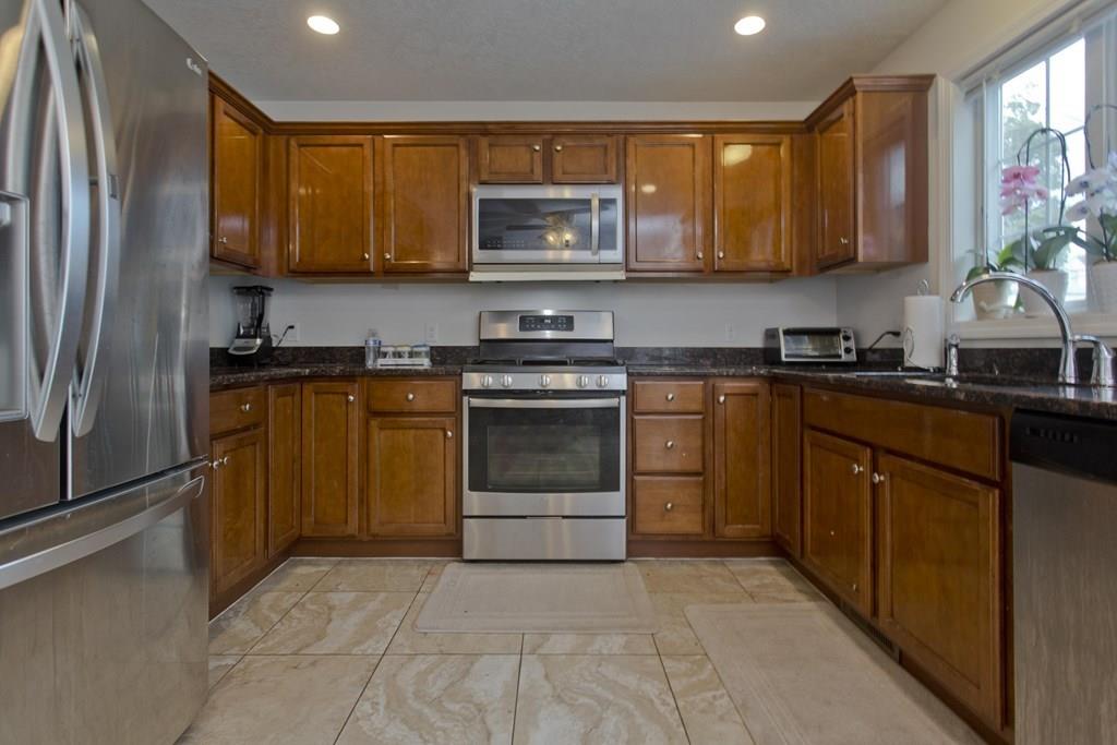 39 Spencer Street Springfield, MA 01118 - Photo 3 of 30 a kitchen with a sink stove and microwave