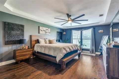 a bedroom with a large bed couch and a window