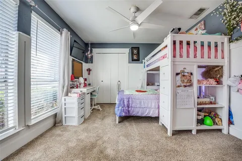 a bedroom with furniture and a flat screen tv