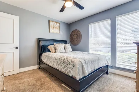 a bedroom with a bed and a large window