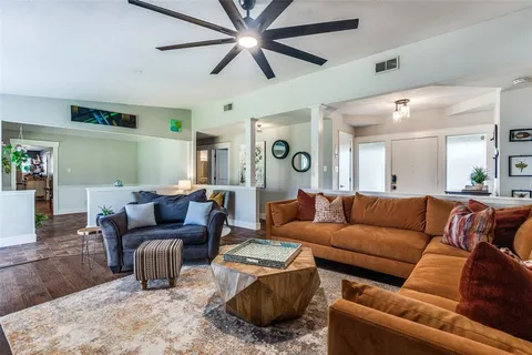 a living room with furniture a view of bedroom and a couch