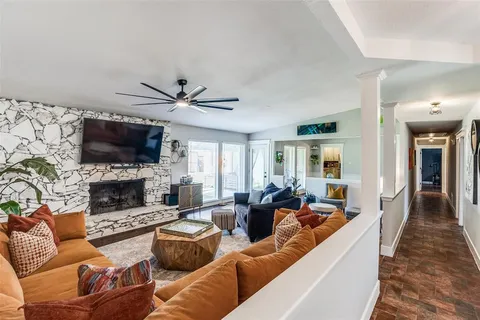a living room with furniture a fireplace and a flat screen tv
