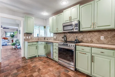a kitchen with cabinets a sink and a stove