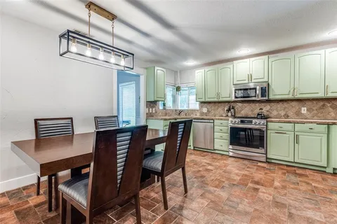 a kitchen with a stove a sink and a refrigerator