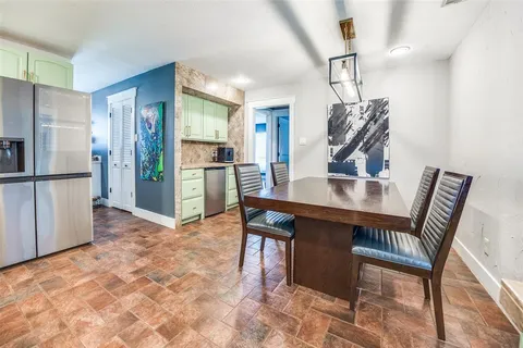 a view of kitchen with furniture and refrigerator