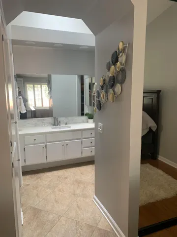 a living room with furniture a fireplace and a large window