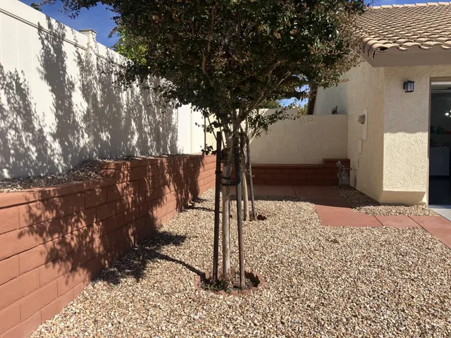 a view of a patio with a table chairs and a backyard