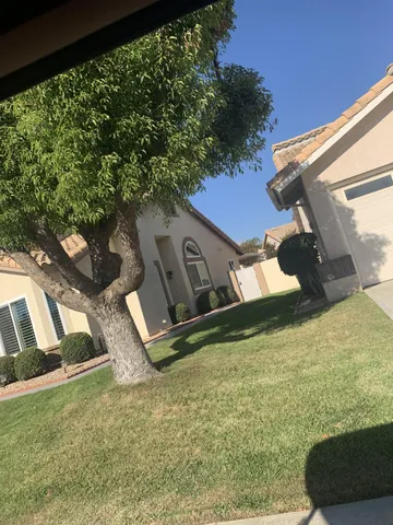 a view of a house with backyard porch and sitting area
