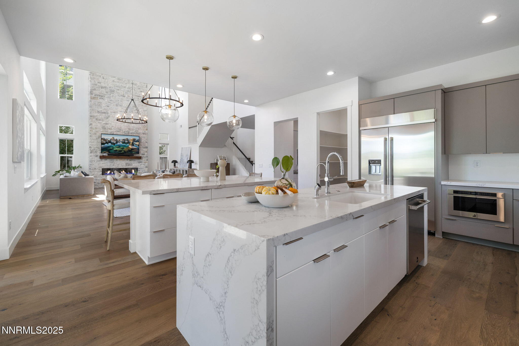 a kitchen with white cabinets and sink