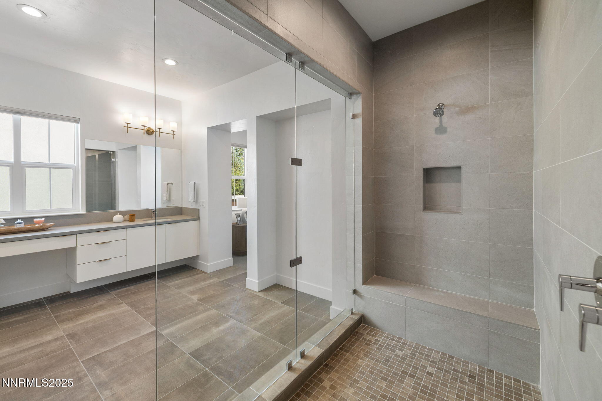 5406 Side Saddle Trail Reno, NV 89511 - Photo 23 of 39 a bathroom with a double vanity sink a mirror and a shower