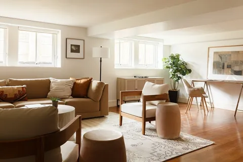 a living room with furniture and wooden floor