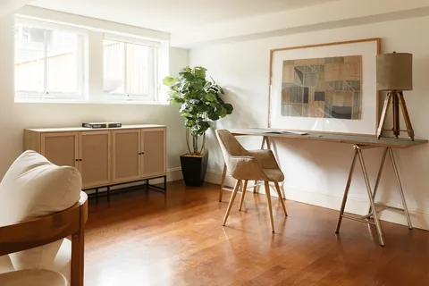 a workspace with furniture and a window