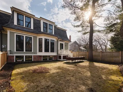 a view of a house with a yard covered with snow in the background