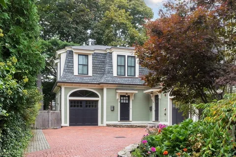 a front view of a house with a garden
