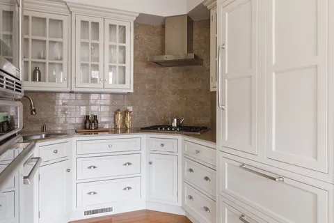 a kitchen with granite countertop white cabinets and sink