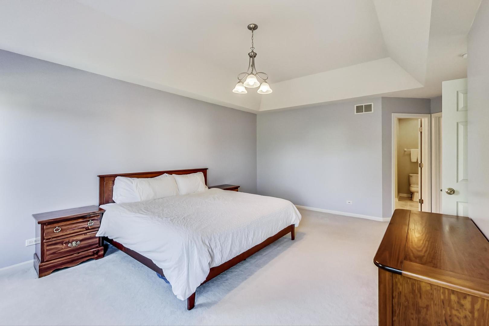 1552 Southgate Road Bartlett, IL 60103 - Photo 15 of 27 a bed room with a bed and a chair