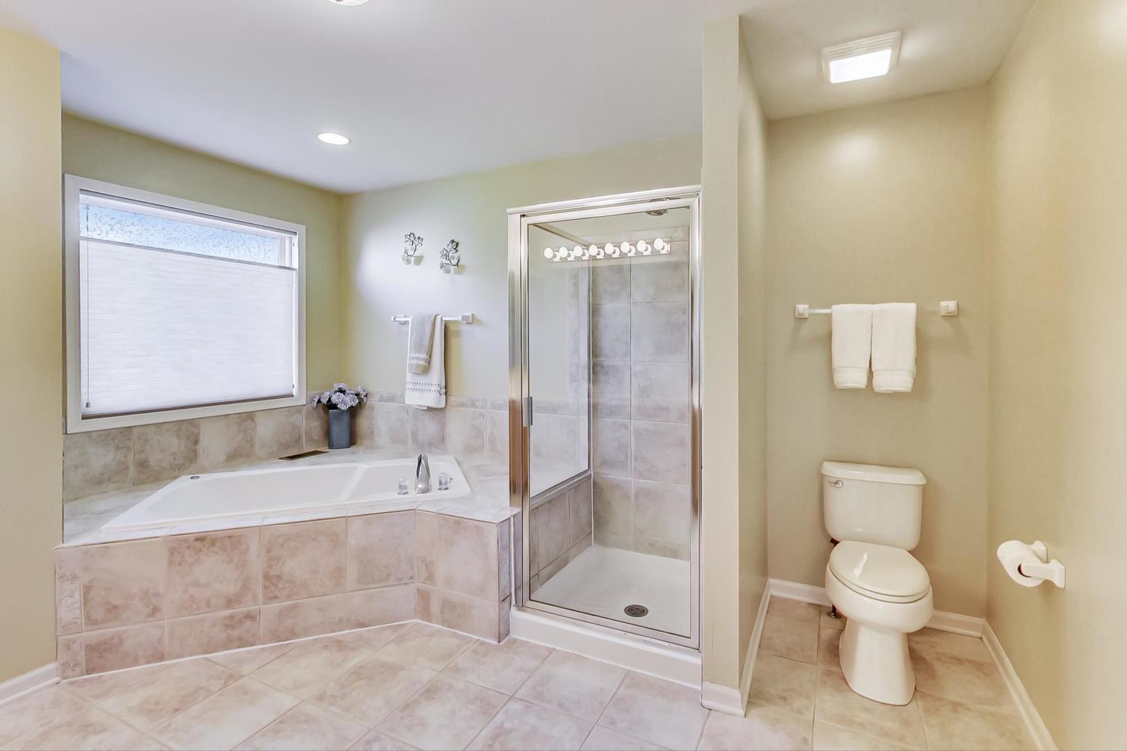 1552 Southgate Road Bartlett, IL 60103 - Photo 16 of 27 a bathroom with a granite countertop sink toilet and shower