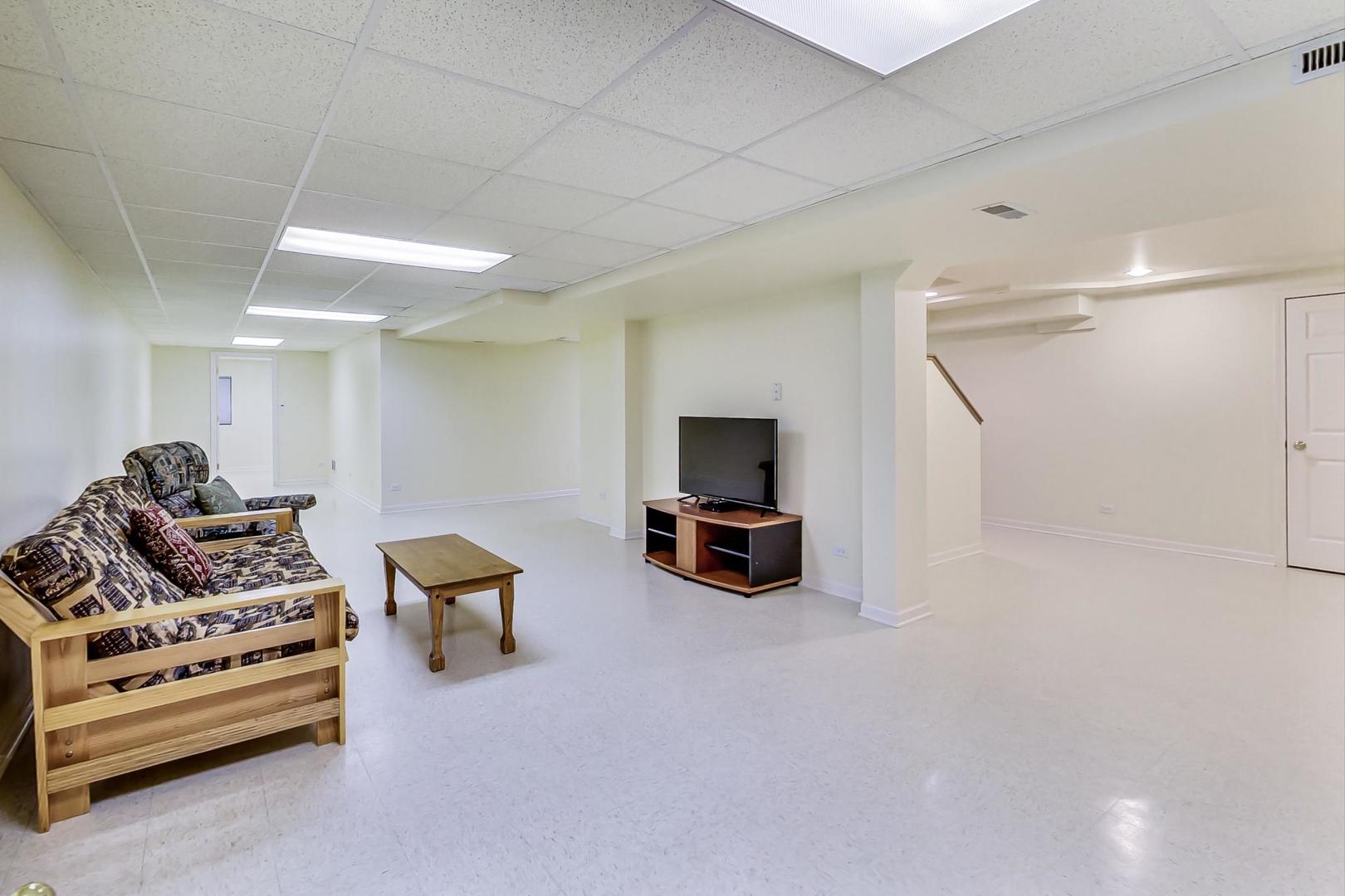 1552 Southgate Road Bartlett, IL 60103 - Photo 20 of 27 a living room with furniture and a flat screen tv