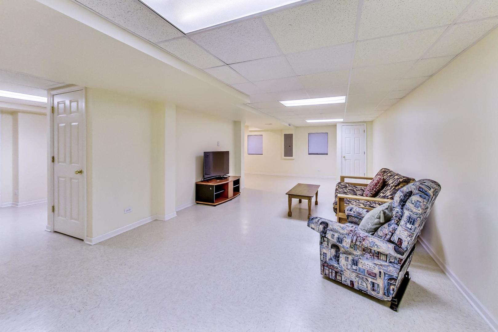 1552 Southgate Road Bartlett, IL 60103 - Photo 21 of 27 a living room with furniture and a flat screen tv