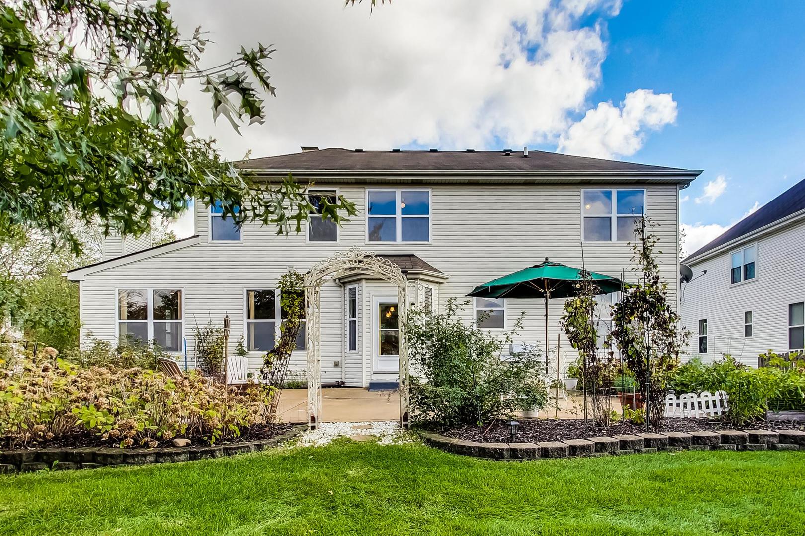 1552 Southgate Road Bartlett, IL 60103 - Photo 23 of 27 a front view of a house with a garden