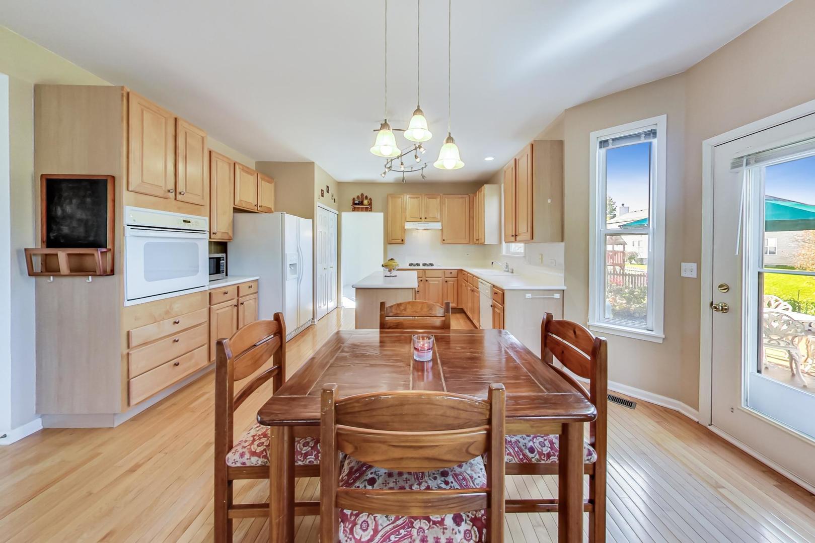 1552 Southgate Road Bartlett, IL 60103 - Photo 10 of 27 a view of a dining room with furniture a chandelier and wooden floor