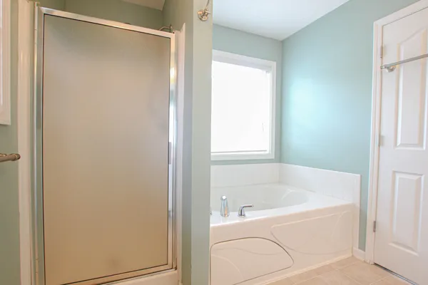 a white bath tub sitting next to a window