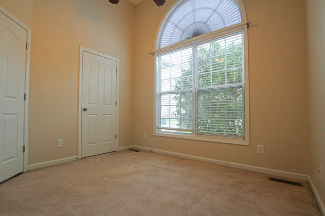 an empty room with a empty space and windows