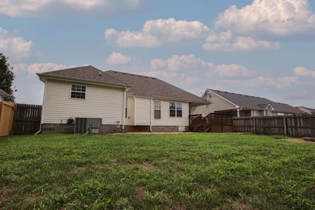 a view of a house with a yard and sitting area