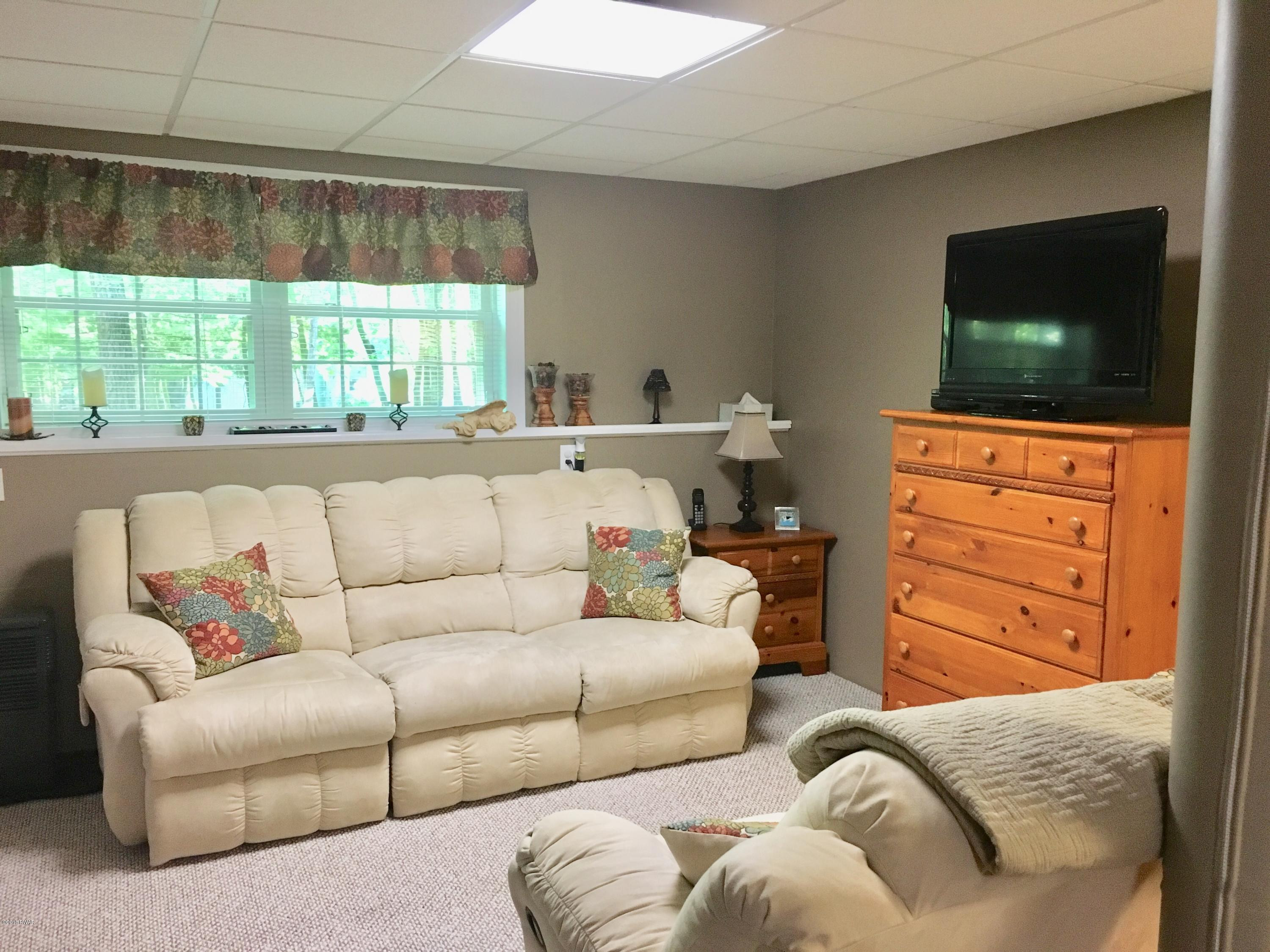 154 Butternut Road Milford, PA 18337 - Photo 8 of 14 a living room with furniture and a flat screen tv