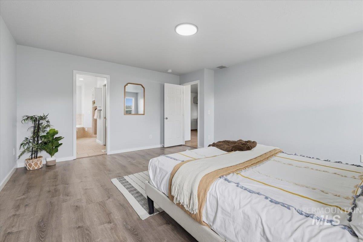 25022 Tumbleweed Road Middleton, ID 83644 - Photo 16 of 41 Bedroom featuring wood finished floors and baseboards