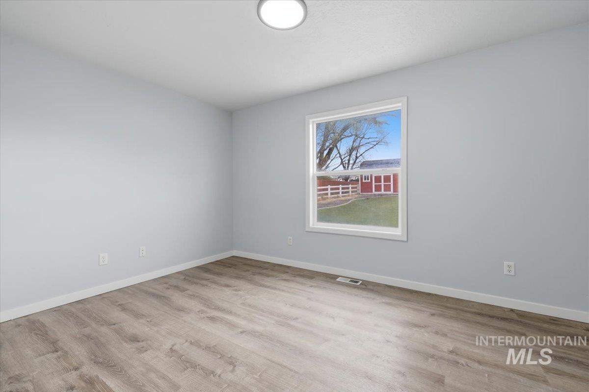 25022 Tumbleweed Road Middleton, ID 83644 - Photo 22 of 41 Unfurnished room with light wood-type flooring