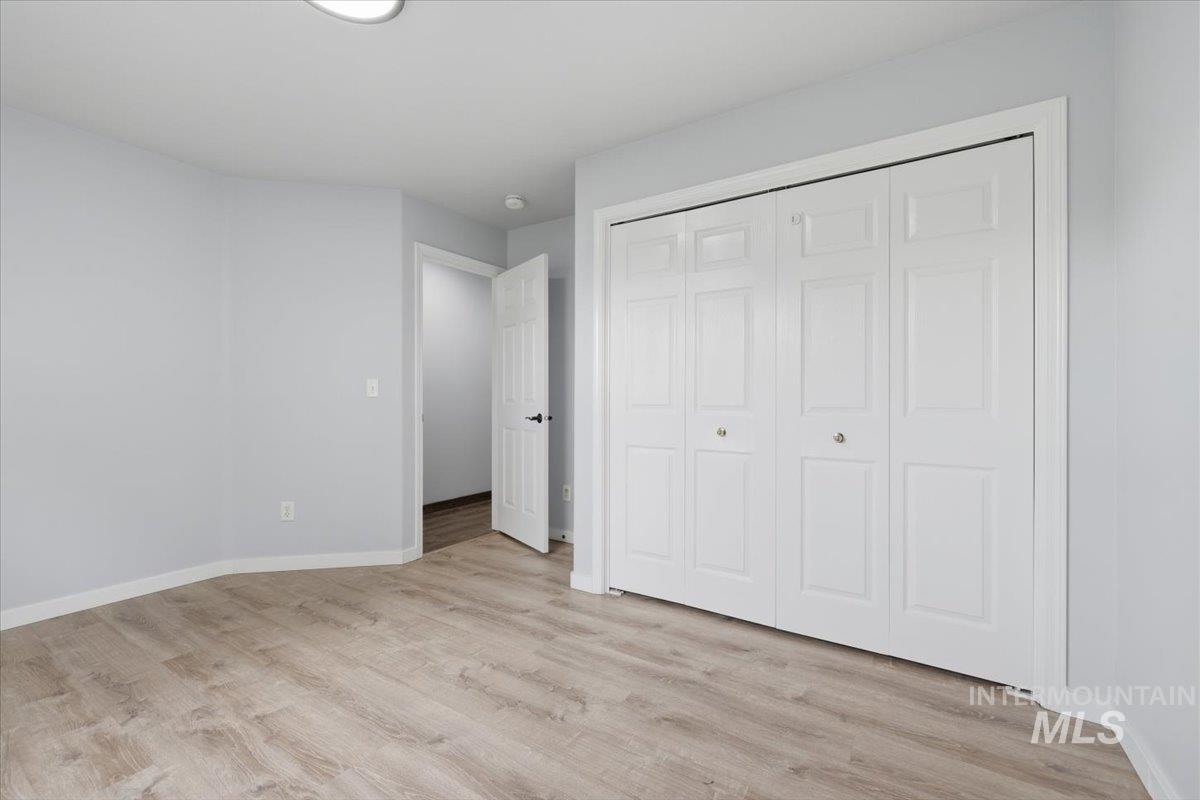 25022 Tumbleweed Road Middleton, ID 83644 - Photo 23 of 41 Unfurnished bedroom featuring light wood-style flooring and a closet