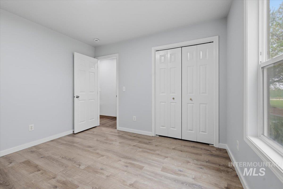 25022 Tumbleweed Road Middleton, ID 83644 - Photo 27 of 41 Unfurnished bedroom featuring light wood-style flooring and a closet