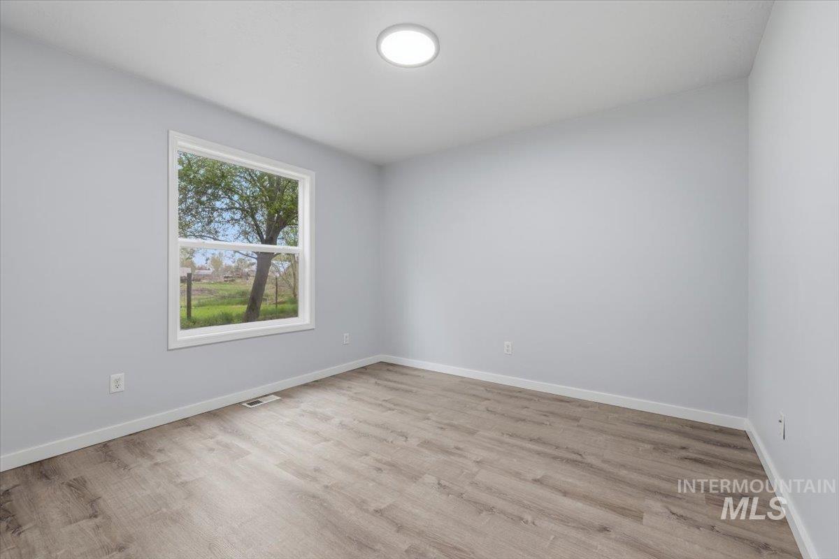 25022 Tumbleweed Road Middleton, ID 83644 - Photo 28 of 41 Spare room with baseboards and light wood-style flooring